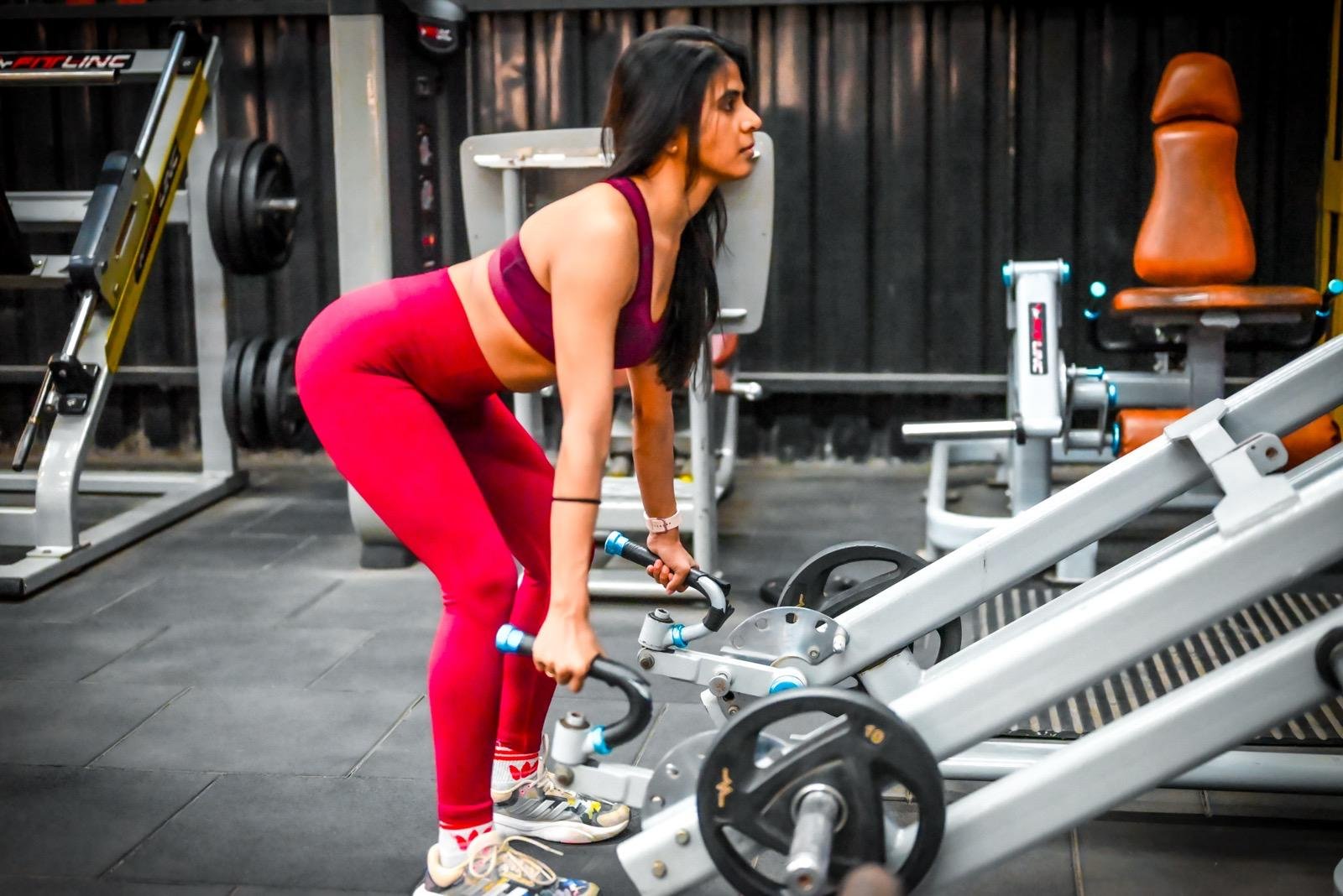 Member training on a cable machine at Muscle Time Fitness